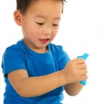 Toddler Holding Blue Paper
