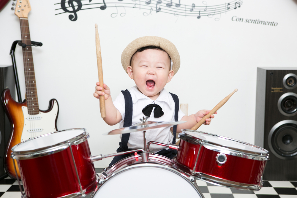 Little boy playing the drums
