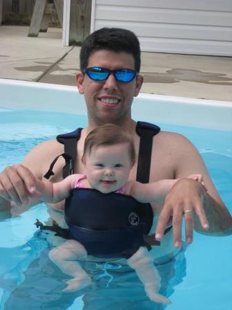 Father with baby in swimming pool